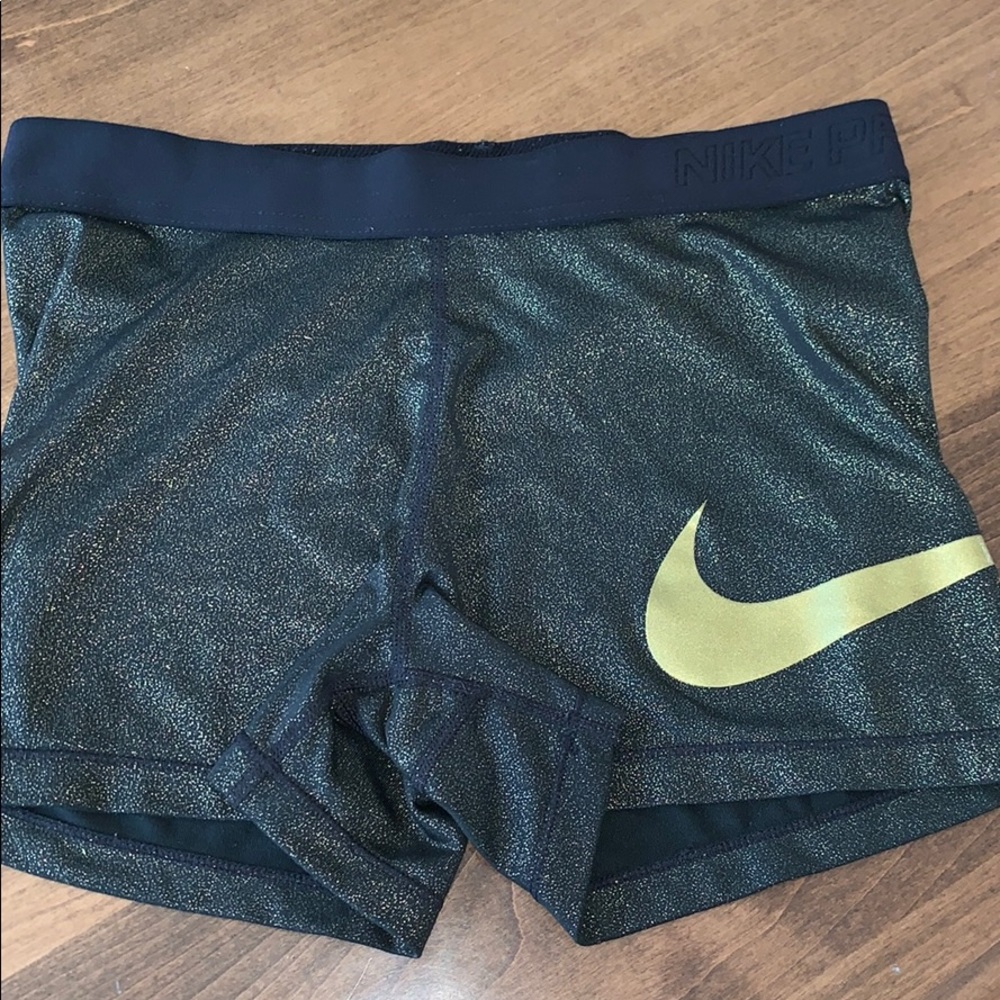 Women’s black and gold Nike pros